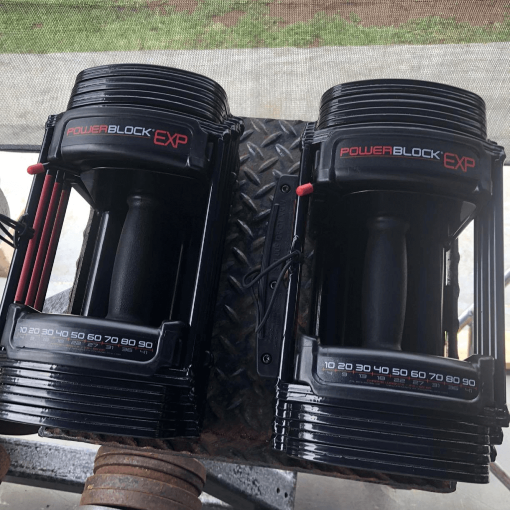 PowerBlock Exp adjustable dumbbells on weight rack Improve Your Grip